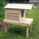 Cat house on platform with extended roof - side view